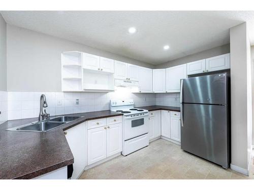 319 Coral Cove Ne, Calgary, AB - Indoor Photo Showing Kitchen With Double Sink