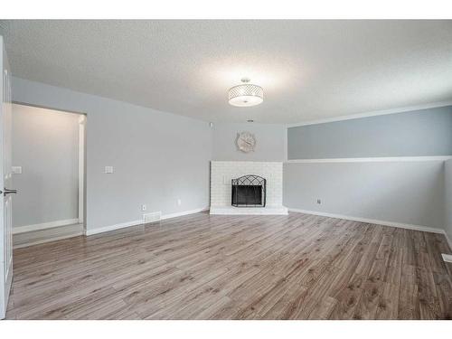139 Pinemill Way Ne, Calgary, AB - Indoor Photo Showing Living Room With Fireplace