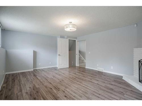 139 Pinemill Way Ne, Calgary, AB - Indoor Photo Showing Other Room With Fireplace