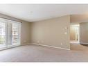 3303-10 Prestwick Bay Se, Calgary, AB  - Indoor Photo Showing Living Room 