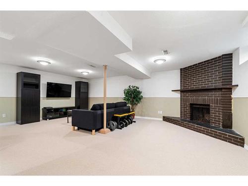 16 Hallmark Place Sw, Calgary, AB - Indoor With Fireplace