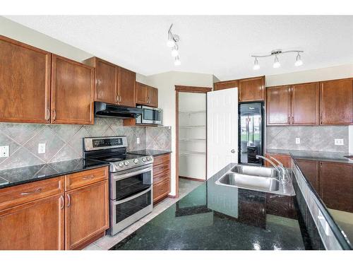 94 Bridlecrest Boulevard Sw, Calgary, AB - Indoor Photo Showing Kitchen With Double Sink