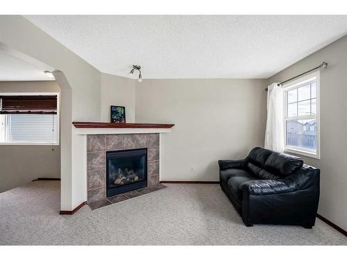 94 Bridlecrest Boulevard Sw, Calgary, AB - Indoor Photo Showing Living Room With Fireplace