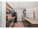 4117-403 Mackenzie Way Sw, Airdrie, AB  - Indoor Photo Showing Kitchen With Double Sink 
