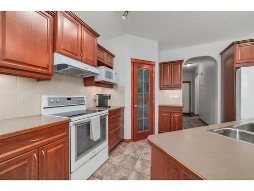 224 Hawkmere View, Chestermere, AB - Indoor Photo Showing Kitchen With Double Sink