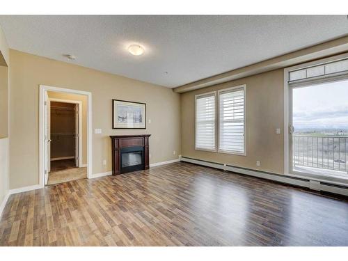 306-207 Sunset Drive, Cochrane, AB - Indoor Photo Showing Other Room With Fireplace