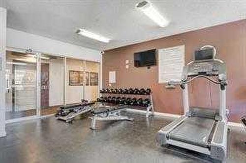 306-207 Sunset Drive, Cochrane, AB - Indoor Photo Showing Gym Room