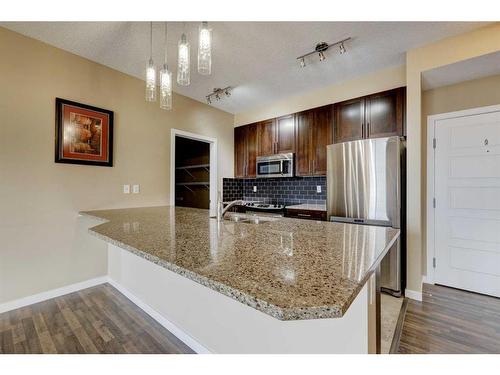 306-207 Sunset Drive, Cochrane, AB - Indoor Photo Showing Kitchen With Stainless Steel Kitchen With Upgraded Kitchen