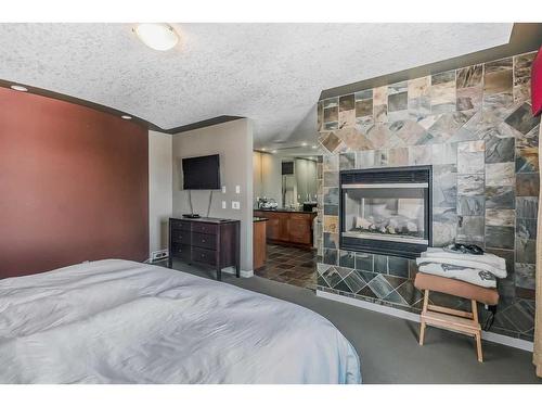 1141 Panorama Hills Landing Nw, Calgary, AB - Indoor Photo Showing Bedroom With Fireplace