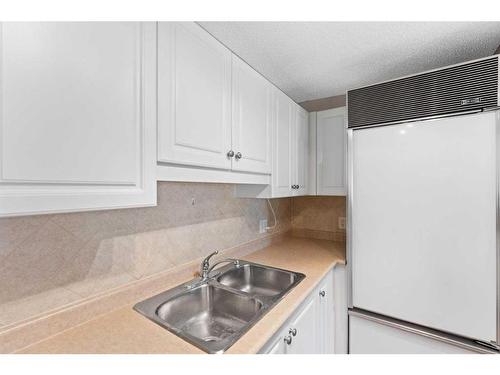 204-5000 Somervale Court Sw, Calgary, AB - Indoor Photo Showing Kitchen With Double Sink