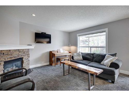 1057 Cranston Drive Se, Calgary, AB - Indoor Photo Showing Living Room With Fireplace