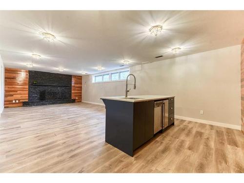 163 Malibou Road Sw, Calgary, AB - Indoor With Fireplace