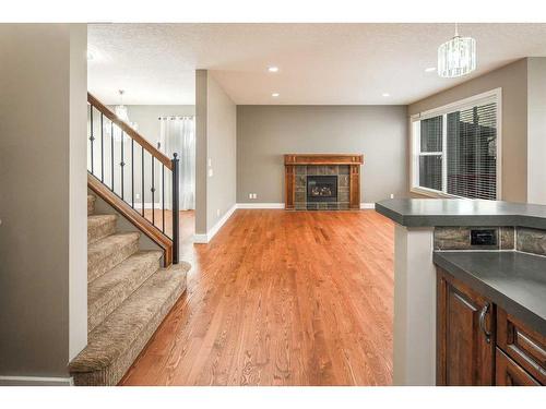 243 St Moritz Drive Sw, Calgary, AB - Indoor Photo Showing Other Room With Fireplace