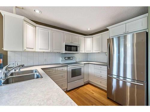 411 Lineham Acres Bay Nw, High River, AB - Indoor Photo Showing Kitchen With Double Sink