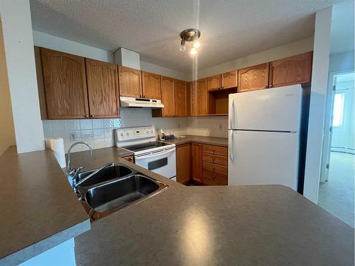 #2307-950 Arbour Lake Road Nw, Calgary, AB - Indoor Photo Showing Kitchen With Double Sink
