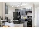 404-15 Saddlestone Way Ne, Calgary, AB  - Indoor Photo Showing Kitchen With Double Sink 