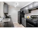 404-15 Saddlestone Way Ne, Calgary, AB  - Indoor Photo Showing Kitchen With Double Sink 