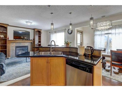 63 Evansmeade Common Nw, Calgary, AB - Indoor Photo Showing Kitchen With Fireplace With Double Sink