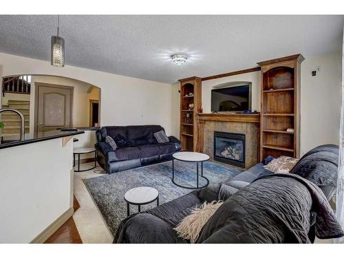 63 Evansmeade Common Nw, Calgary, AB - Indoor Photo Showing Living Room With Fireplace