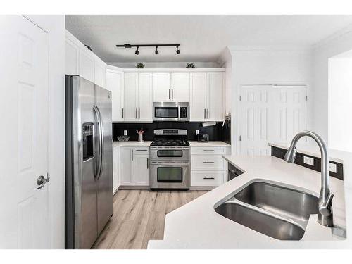 18372 Chaparral Street Se, Calgary, AB - Indoor Photo Showing Kitchen With Double Sink