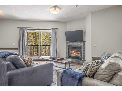 228-901 Mountain Street, Canmore, AB - Indoor Photo Showing Living Room With Fireplace