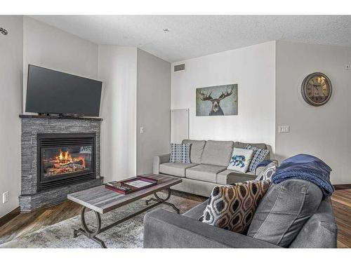 228-901 Mountain Street, Canmore, AB - Indoor Photo Showing Living Room With Fireplace