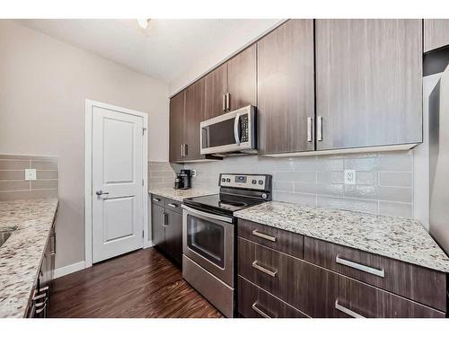 202-200 Cranfield Common Se, Calgary, AB - Indoor Photo Showing Kitchen With Upgraded Kitchen