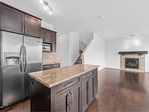 920 Prairie Springs Drive Sw, Airdrie, AB - Indoor Photo Showing Kitchen With Fireplace With Stainless Steel Kitchen