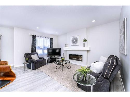 15 Midgrove Drive Sw, Airdrie, AB - Indoor Photo Showing Living Room With Fireplace