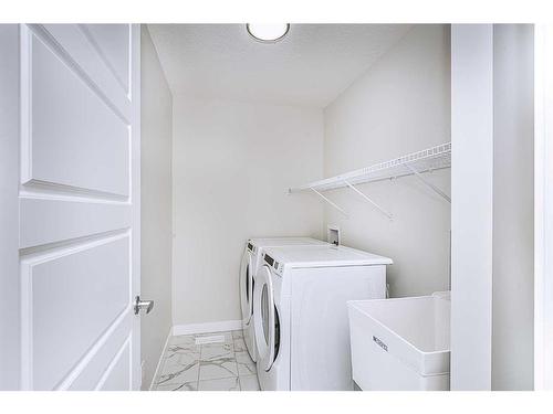 15 Midgrove Drive Sw, Airdrie, AB - Indoor Photo Showing Laundry Room