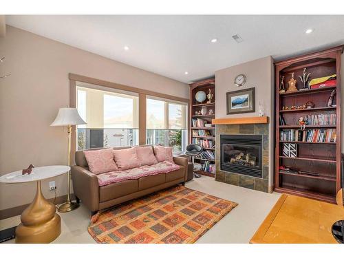 86 Slopes Point Sw, Calgary, AB - Indoor Photo Showing Living Room With Fireplace