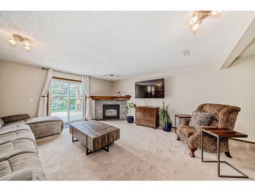 169 Somerside Green Sw, Calgary, AB - Indoor Photo Showing Living Room With Fireplace