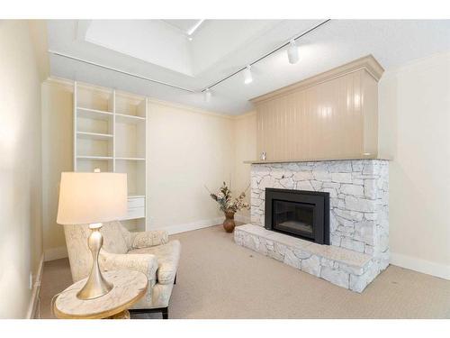 3-68 Baycrest Place Sw, Calgary, AB - Indoor Photo Showing Living Room With Fireplace