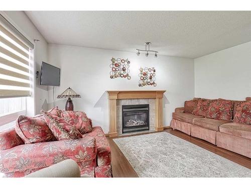 101 Saddlecrest Green Ne, Calgary, AB - Indoor Photo Showing Living Room With Fireplace