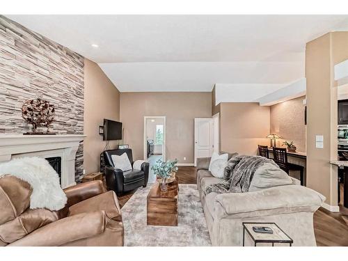 271214 Range Road 13 Nw, Airdrie, AB - Indoor Photo Showing Living Room With Fireplace