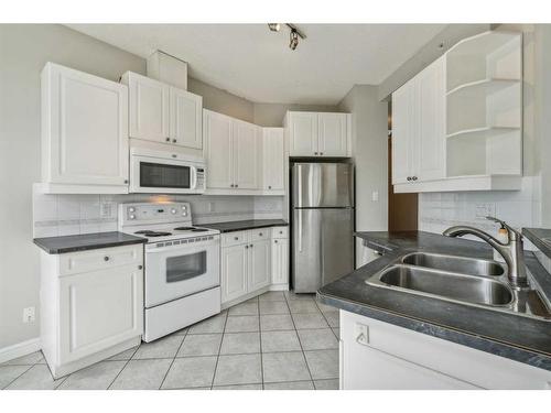 302-910 70 Avenue Sw, Calgary, AB - Indoor Photo Showing Kitchen With Double Sink