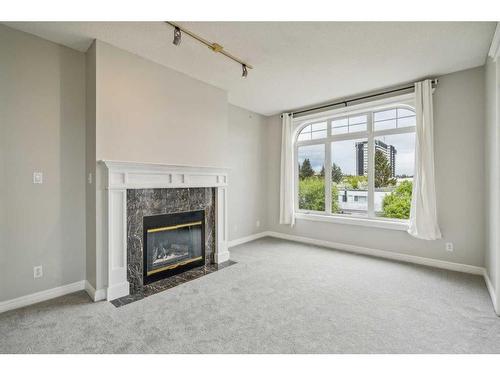 302-910 70 Avenue Sw, Calgary, AB - Indoor Photo Showing Living Room With Fireplace