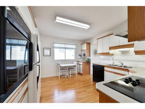 128 Gainsborough Drive Sw, Calgary, AB - Indoor Photo Showing Kitchen With Double Sink
