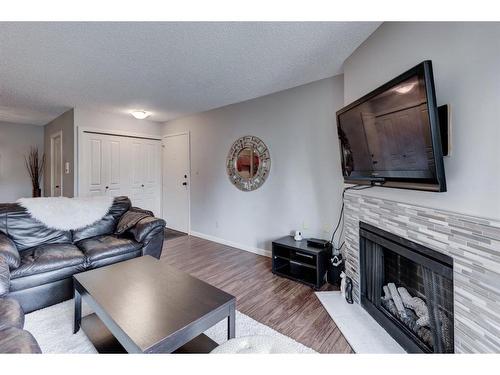 624-6400 Coach Hill Road Sw, Calgary, AB - Indoor Photo Showing Living Room With Fireplace