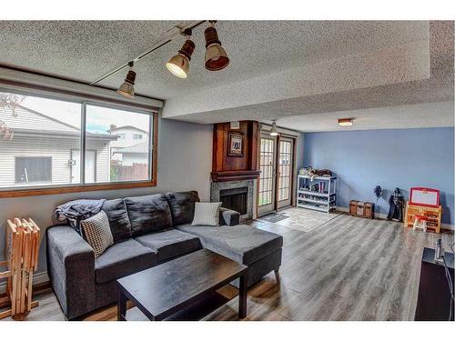 220 Templewood Road Ne, Calgary, AB - Indoor Photo Showing Living Room With Fireplace