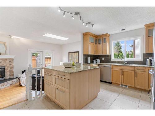 16 Woodglen Gate Sw, Calgary, AB - Indoor Photo Showing Kitchen With Fireplace With Double Sink