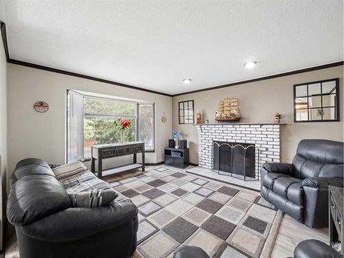395 Cantrell Drive Sw, Calgary, AB - Indoor Photo Showing Living Room With Fireplace