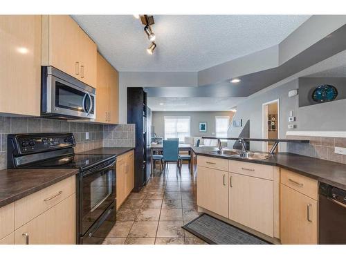 3138 New Brighton Gardens Se, Calgary, AB - Indoor Photo Showing Kitchen With Double Sink