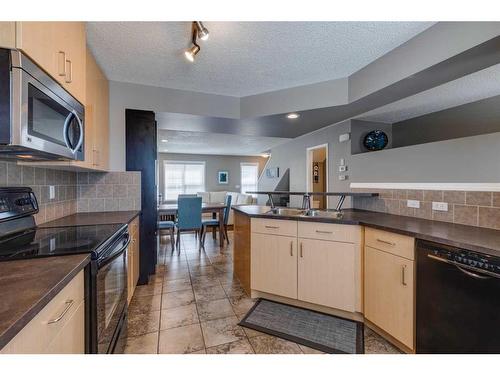 3138 New Brighton Gardens Se, Calgary, AB - Indoor Photo Showing Kitchen With Double Sink