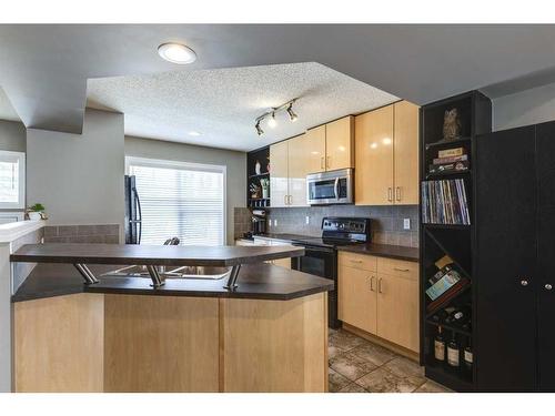 3138 New Brighton Gardens Se, Calgary, AB - Indoor Photo Showing Kitchen With Double Sink