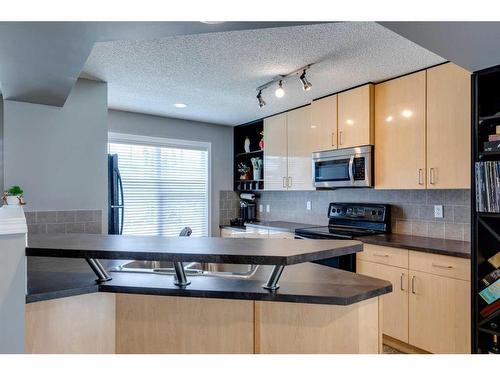 3138 New Brighton Gardens Se, Calgary, AB - Indoor Photo Showing Kitchen With Double Sink