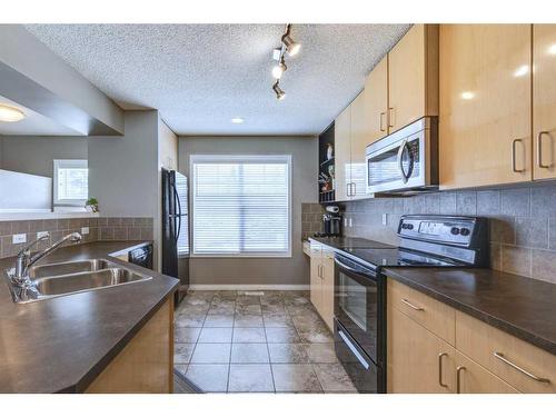 3138 New Brighton Gardens Se, Calgary, AB - Indoor Photo Showing Kitchen With Double Sink