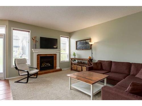 47 Cougarstone Common Sw, Calgary, AB - Indoor Photo Showing Living Room With Fireplace