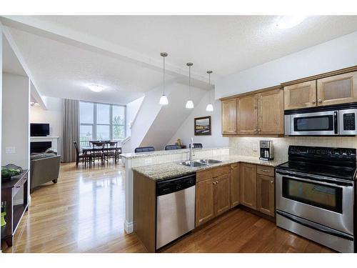 1307-10221 Tuscany Boulevard Nw, Calgary, AB - Indoor Photo Showing Kitchen With Stainless Steel Kitchen With Double Sink