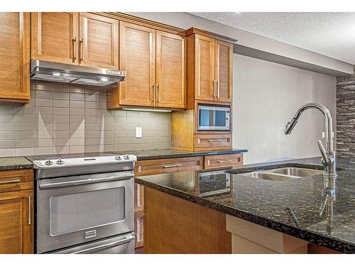 120-106 Stewart Creek Landing, Canmore, AB - Indoor Photo Showing Kitchen With Double Sink